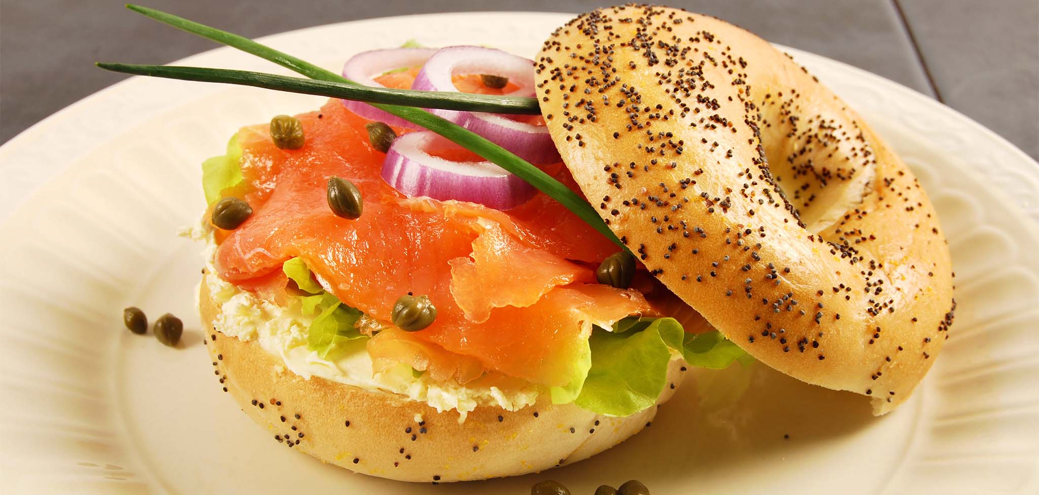 Lox Salmon Bagel with capers, onions, cream cheese and chives is a classic.